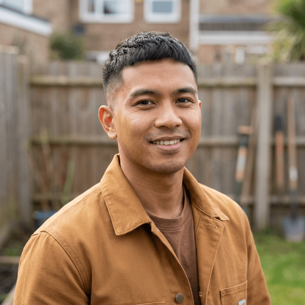 Michael Tran in a button-down shirt standing in a bright bathroom