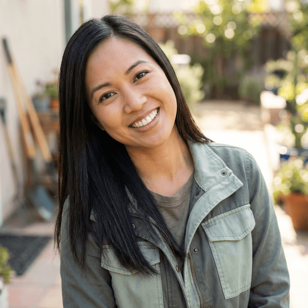 Danielle Roy in a casual sweater smiling in her renovated kitchen